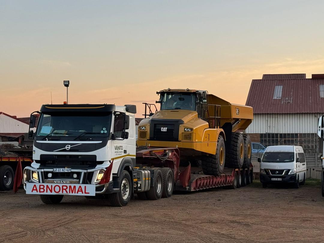 Articulated dump truck transported on a lowbed trailer