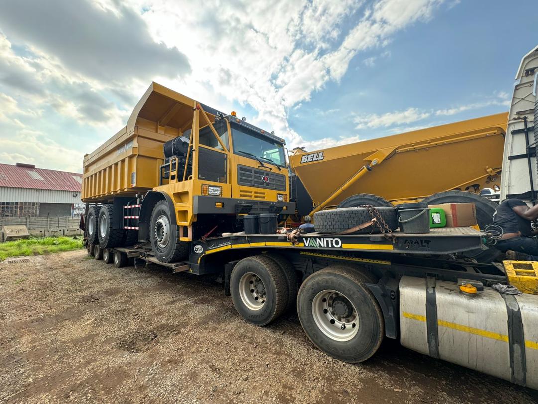 Large rigid dump truck loaded on a lowbed trailer