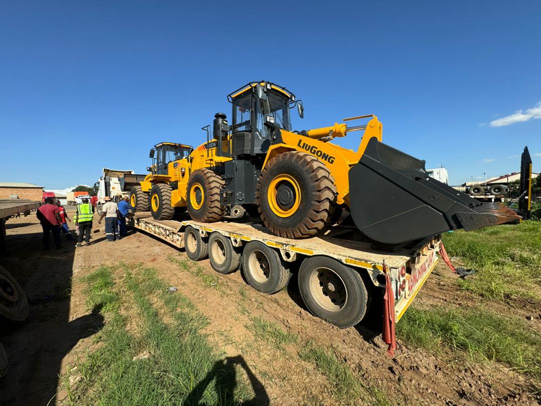 Two wheel loaders secured on a lowbed trailer