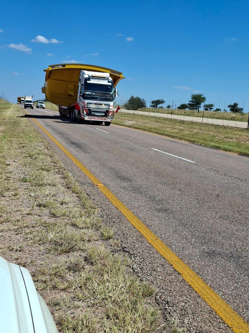 Abnormal-load truck transporting a large mining body on a South African road