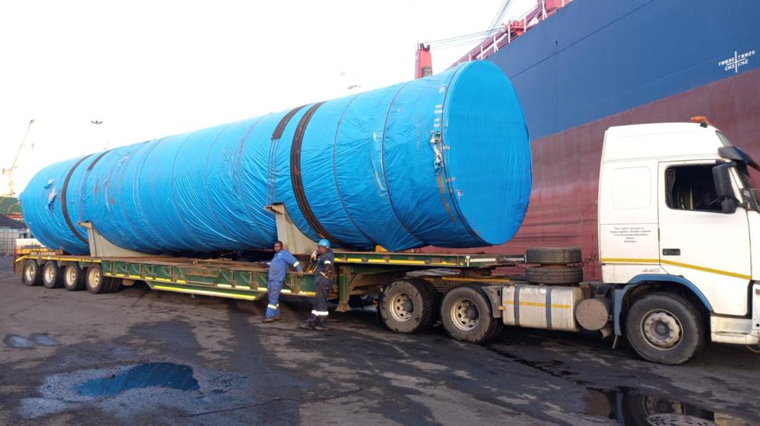 Large cylindrical project cargo on a multi-axle trailer at a port